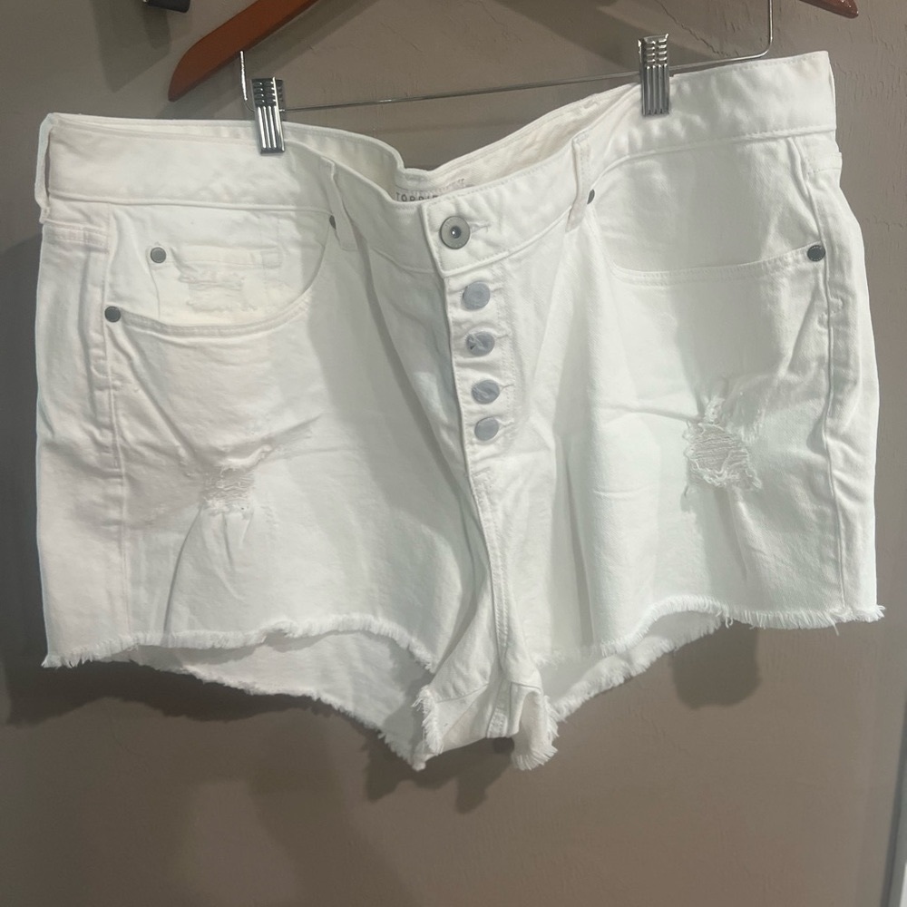 White jean button up short with destruction.